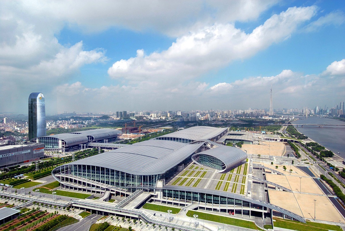 Aerial view of the China Import & Export Fair Complex with spacious halls, close to the river and the Guangzhou skyline.