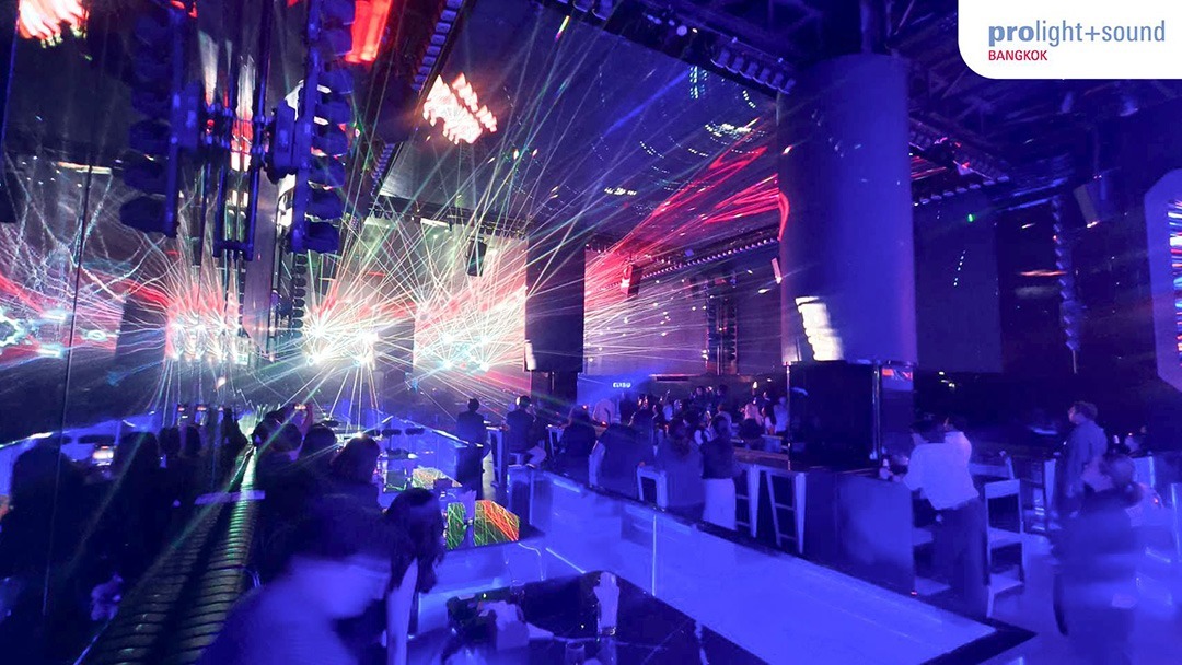Club scene with audience, laser light show and immersive visuals on a large stage
